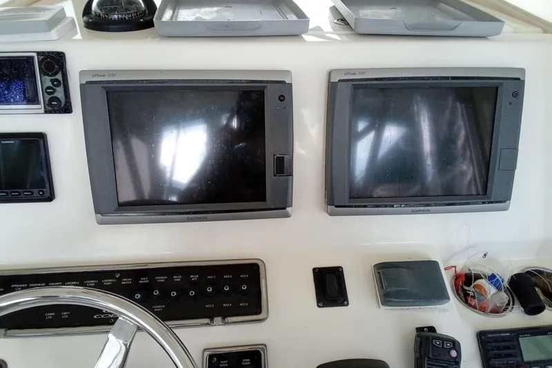 Slide: The Image of 2014 Cobia 296 Center Console dashboard with Garmin GPS displays and controls. - 28