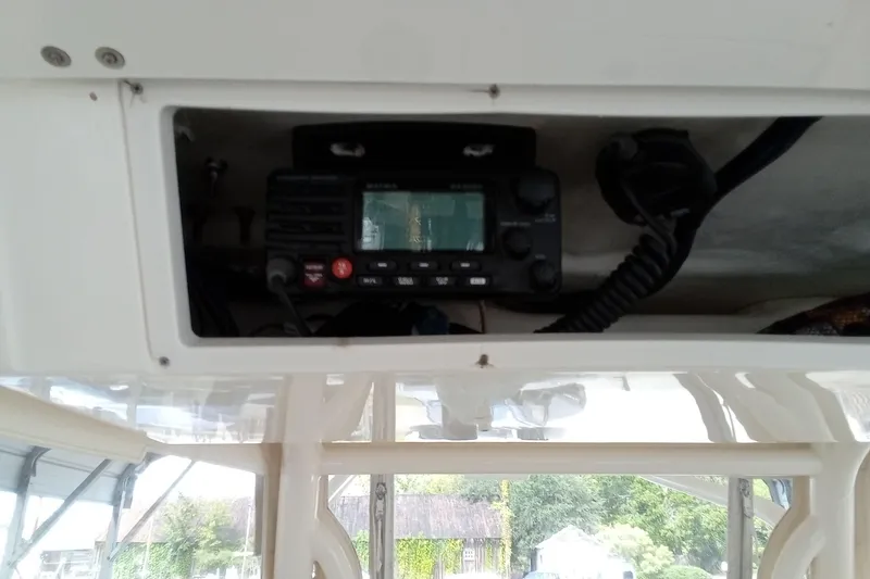 Slide: The Image of 2014 Cobia 296 Center Console boat radio equipment in storage compartment. - 30