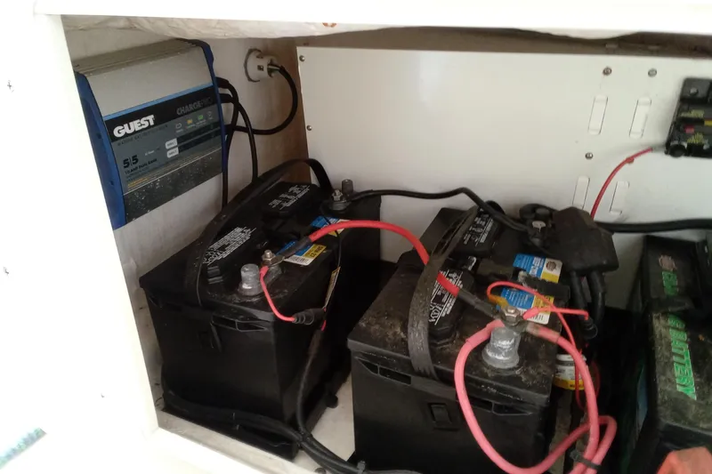 Slide: The Image of Battery compartment of 2014 Cobia 296 Center Console with charger and wiring. - 31