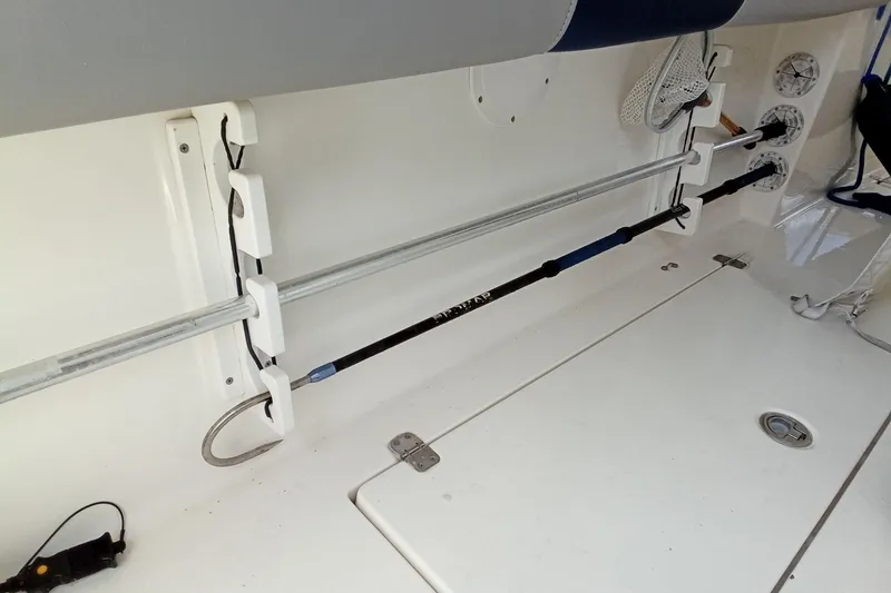 Slide: The Image of 2014 Cobia 296 Center Console fishing rod holders and storage area. - 34