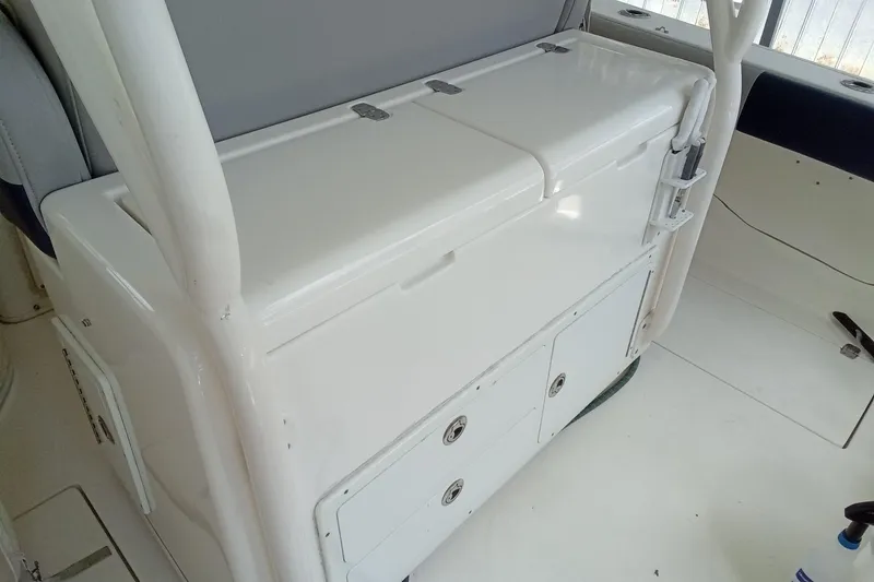 Slide: The Image of 2014 Cobia 296 Center Console boat interior with storage compartments and seating. - 35