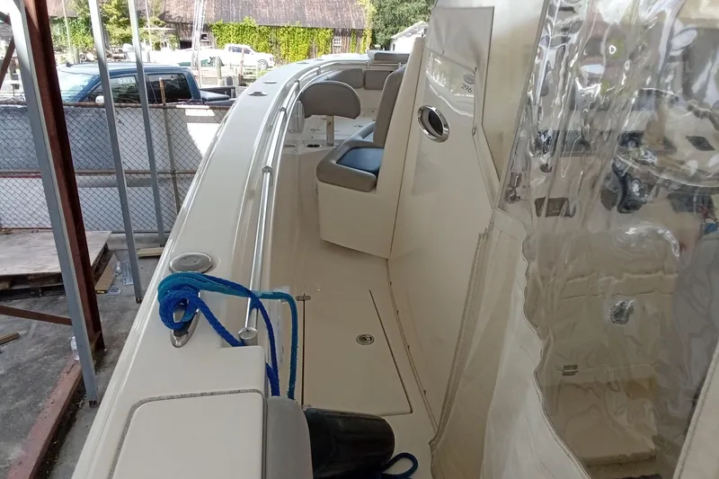 Slide: The Image of 2014 Cobia 296 Center Console boat interior with seating and blue rope. - 36