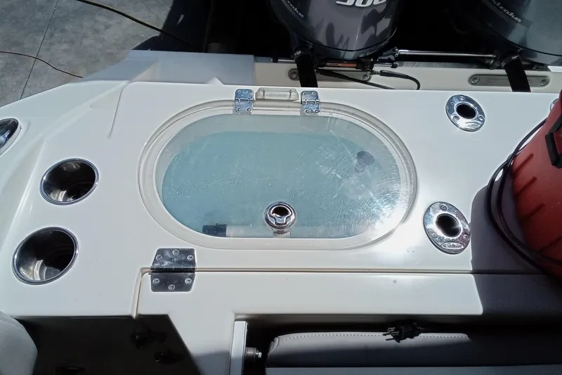 Slide: The Image of 2014 Cobia 296 Center Console boat with livewell and rod holders. - 39