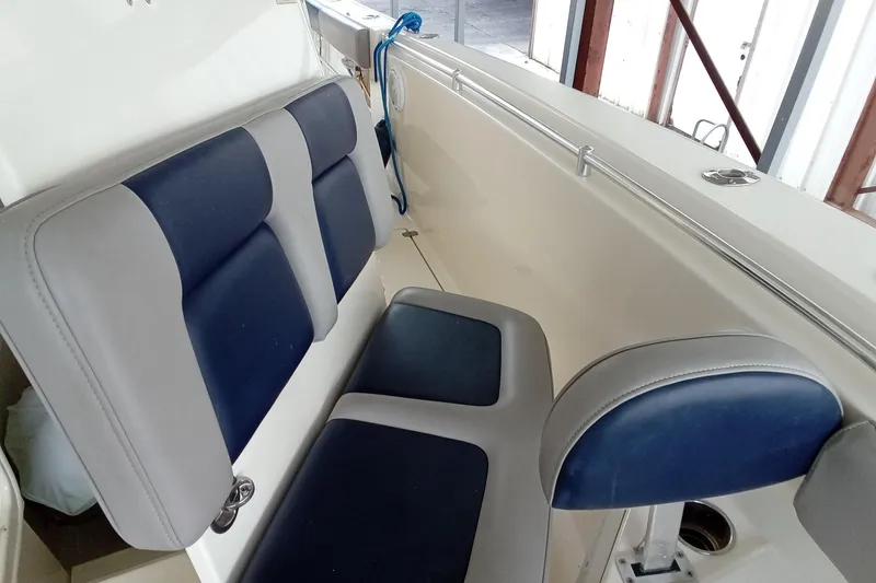 Slide: The Image of 2014 Cobia 296 Center Console boat interior with blue and gray seating. - 44