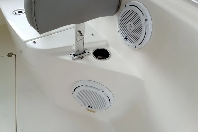 Slide: The Image of 2014 Cobia 296 Center Console boat interior with speakers and seating. - 46