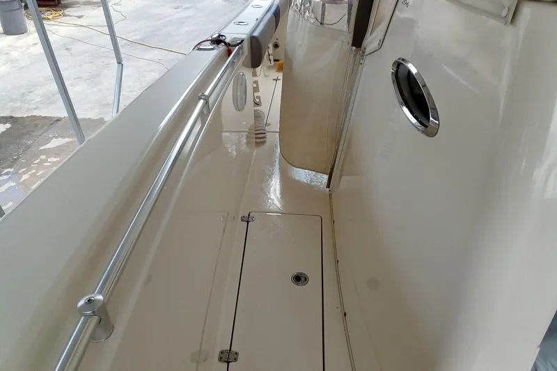 Slide: The Image of 2014 Cobia 296 Center Console boat interior with sleek design and stainless steel railings. - 48