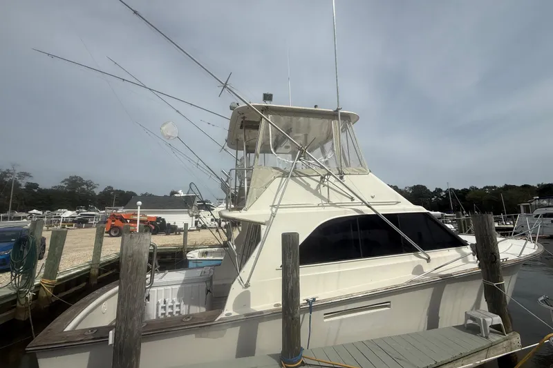 The Image of 1986 Ocean Yachts 38 Super Sport docked at a marina, side view. - 0