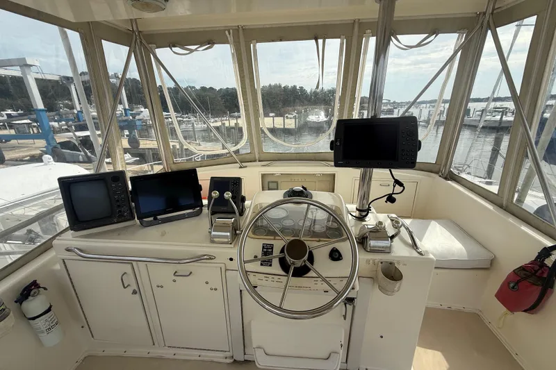 Slide: The Image of 1986 Ocean Yachts 38 Super Sport helm with navigation equipment and marina view. - 10