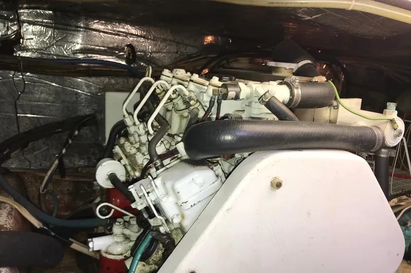 Slide: The Image of Engine room of 1986 Ocean Yachts 38 Super Sport, showcasing mechanical components and hoses. - 22