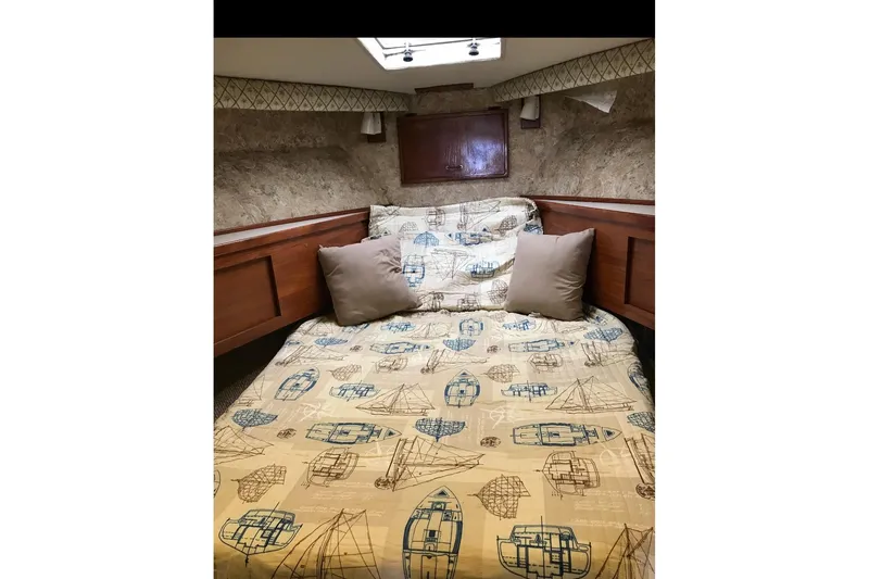 Slide: The Image of Cozy cabin interior of 1986 Ocean Yachts 38 Super Sport with nautical-themed bedding. - 25