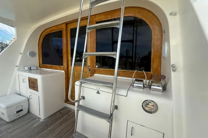 Slide: The Image of 1986 Ocean Yachts 38 Super Sport boat interior with ladder and wooden accents. - 3