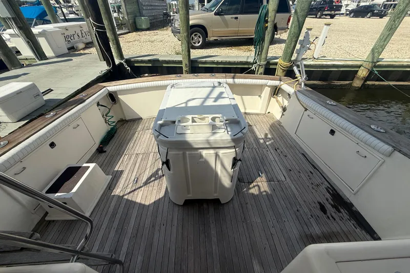Slide: The Image of 1986 Ocean Yachts 38 Super Sport deck with storage and seating, docked at marina. - 8