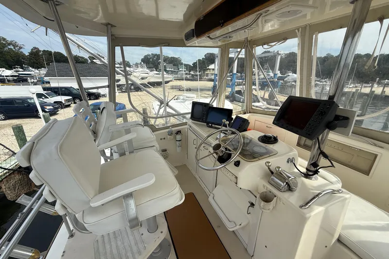 Slide: The Image of 1986 Ocean Yachts 38 Super Sport helm with navigation equipment and seating. - 9