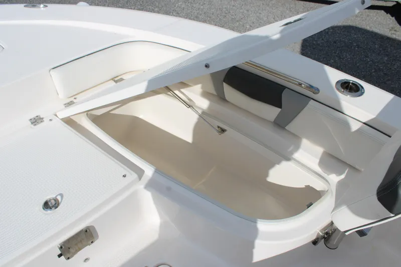 Slide: The Image of 2023 Robalo 226 Cayman boat storage compartment with open hatch, showcasing spacious interior. - 11