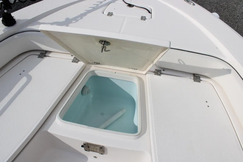 Slide: The Image of 2023 Robalo 226 Cayman boat with open storage compartment on deck. - 12