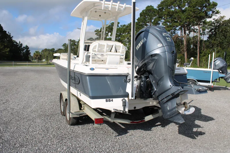 Slide: The Image of 2023 Robalo 226 Cayman boat with Yamaha V6 engine on a trailer. - 2