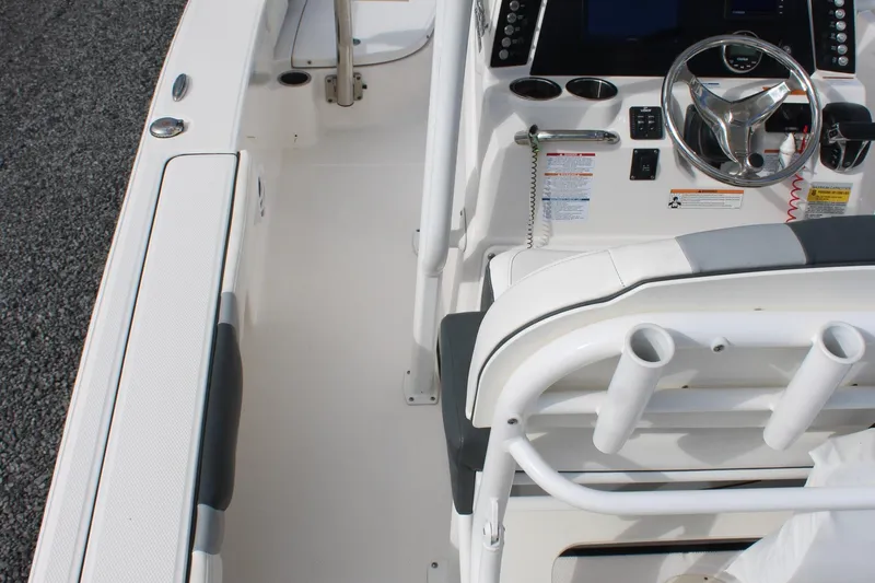 Slide: The Image of 2023 Robalo 226 Cayman boat interior with steering console and seating area. - 22