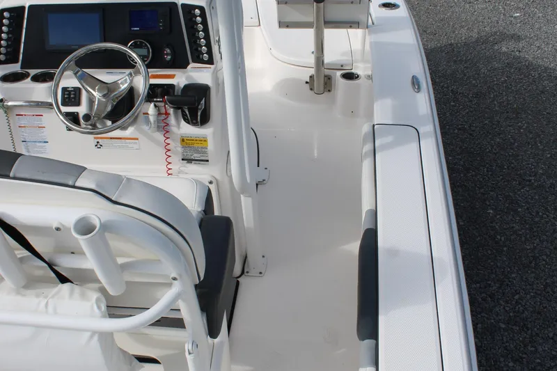 Slide: The Image of 2023 Robalo 226 Cayman boat interior with steering console and seating area. - 23
