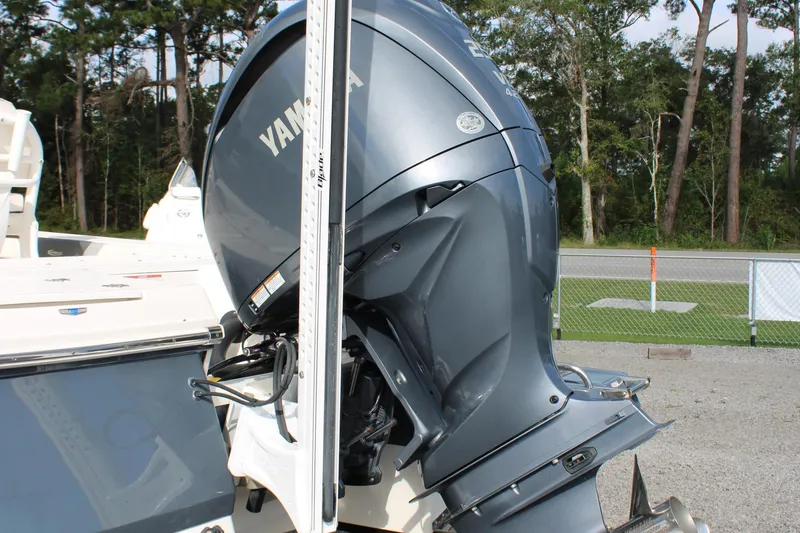 Slide: The Image of 2023 Robalo 226 Cayman with Yamaha outboard motor, parked outdoors. - 28