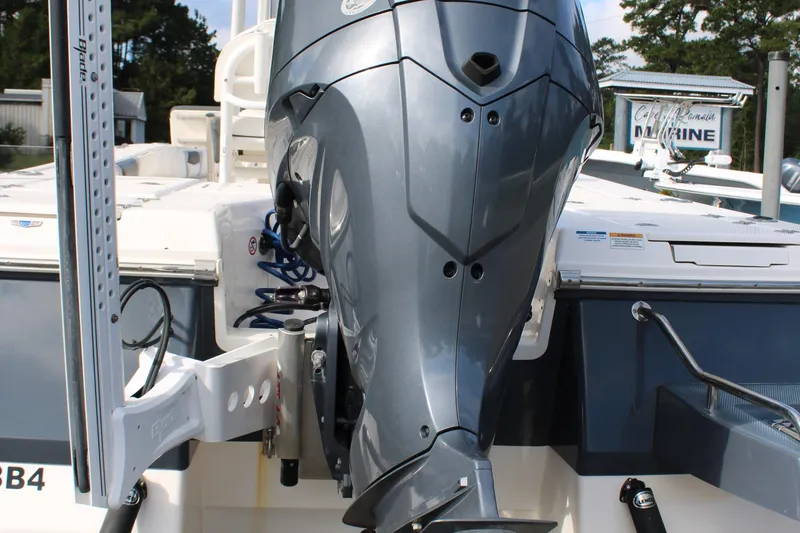 Slide: The Image of 2023 Robalo 226 Cayman boat with powerful outboard motor, docked outdoors. - 29