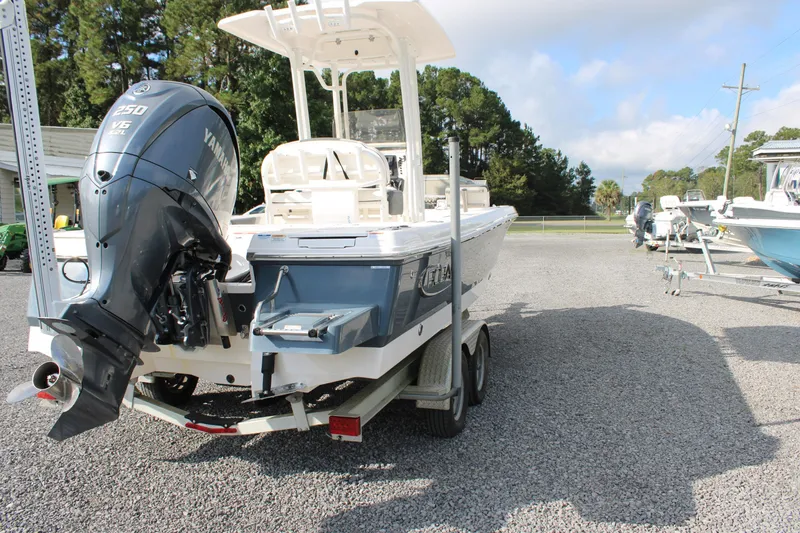 Slide: The Image of 2023 Robalo 226 Cayman boat with Yamaha V6 engine on trailer, parked outdoors. - 3