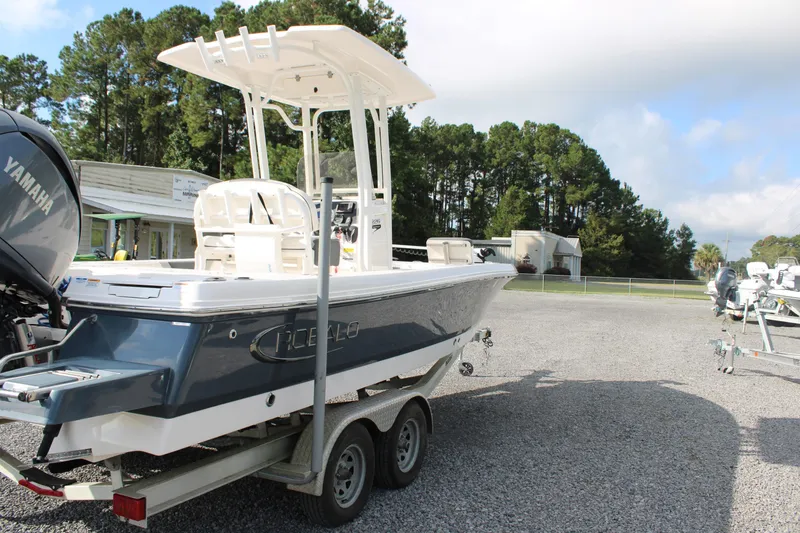 Slide: The Image of 2023 Robalo 226 Cayman boat on trailer with Yamaha engine, parked outdoors. - 5