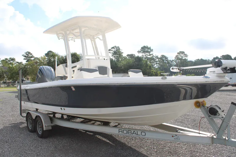 Slide: The Image of 2023 Robalo 226 Cayman boat on trailer, parked outdoors. - 6