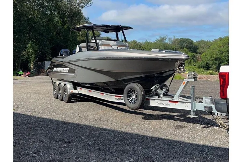 The Image of 2023 Sunsation 32 CCX boat on trailer under blue sky. - 0