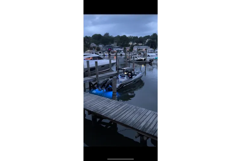 Slide: The Image of 2023 Sunsation 32 CCX boat docked at a marina during twilight. - 7