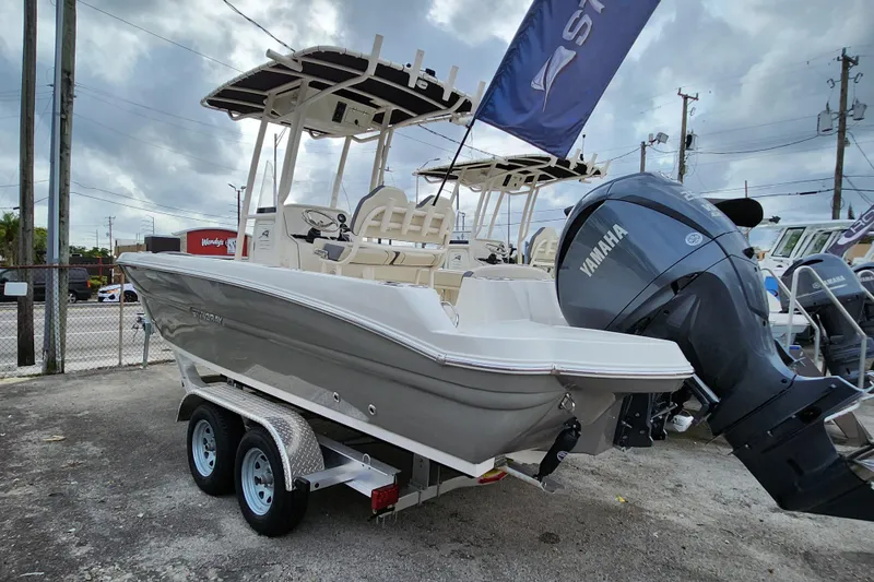 Slide: The Image of 2023 Stingray 236 CC boat with Yamaha engine on a trailer, outdoor display. - 3
