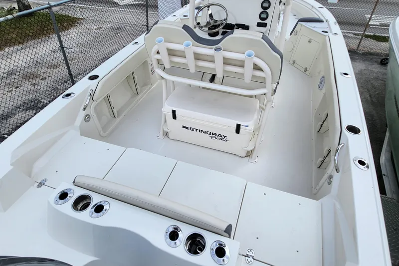 Slide: The Image of 2023 Stingray 236 CC boat interior with seating, storage, and steering console. - 6
