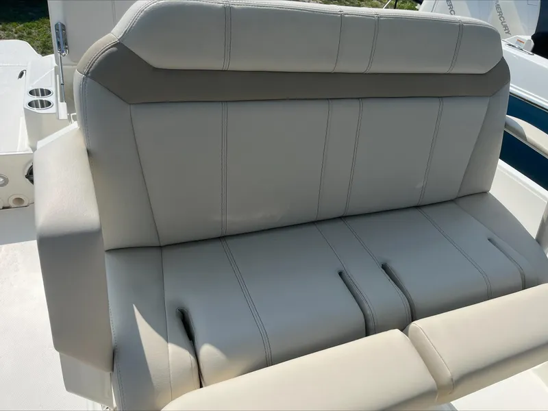 Slide: The Image of 2023 Boston Whaler 280 Dauntless helm with steering wheel, controls, and navigation display. - 12