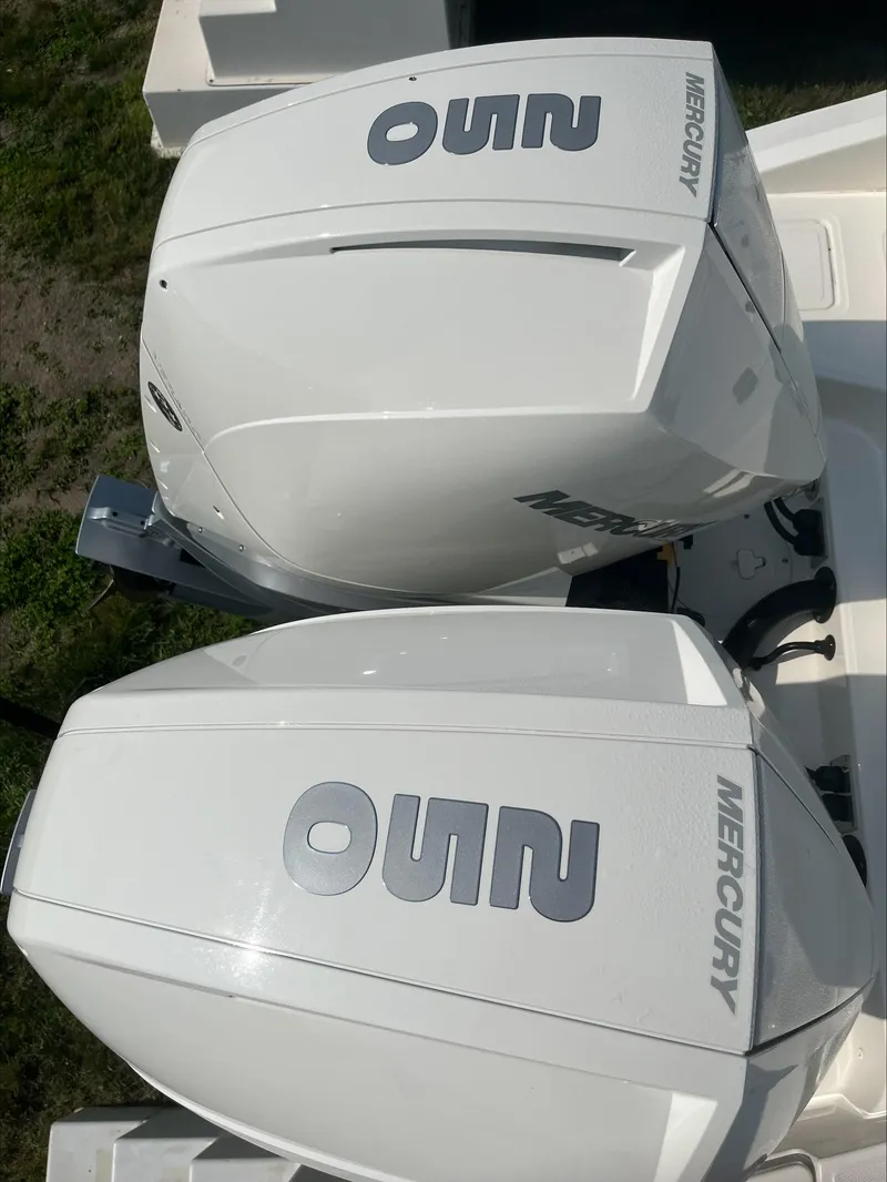 Slide: The Image of Twin Mercury outboard engines on a 2023 Boston Whaler 280 Dauntless boat. - 2