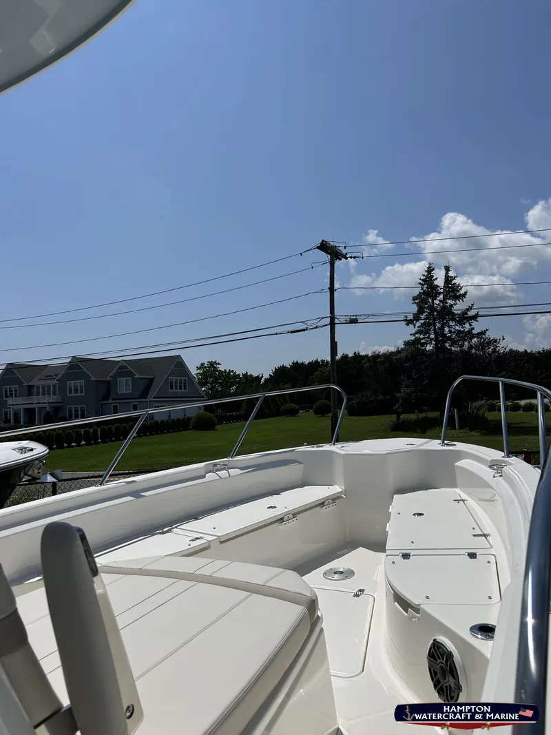 Slide: The Image of 2023 Boston Whaler 280 Dauntless boat deck under clear blue sky. - 21