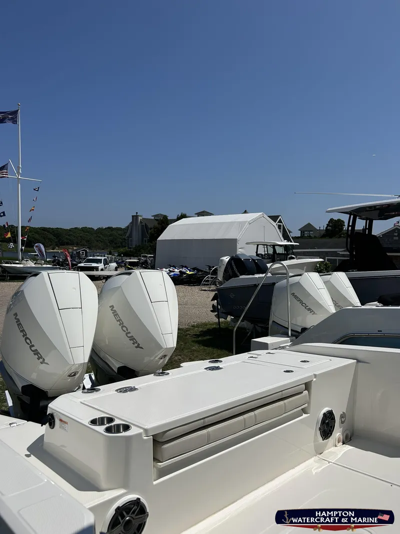 Slide: The Image of 2023 Boston Whaler 280 Dauntless boat with twin Mercury engines at a marina. - 3