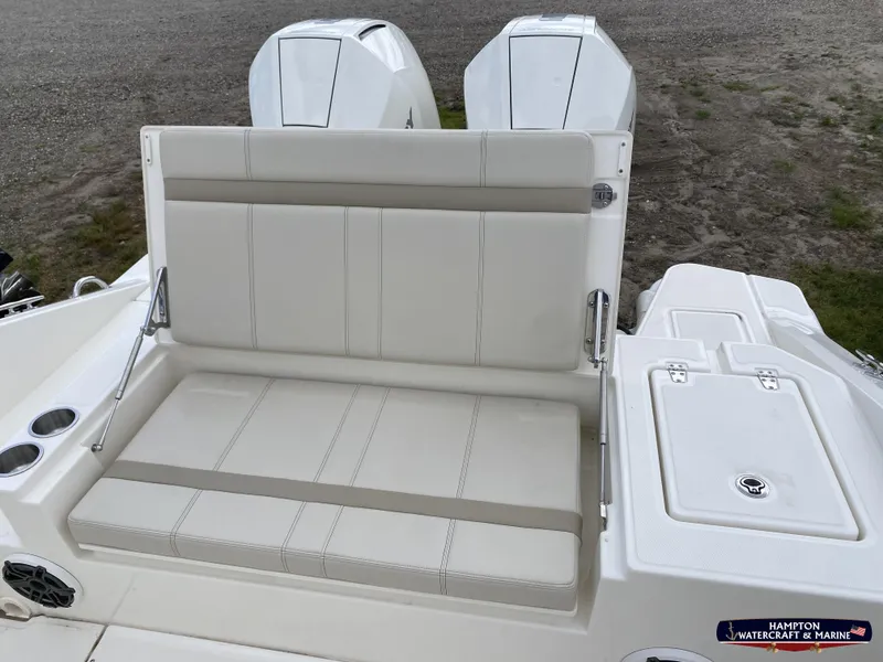 Slide: The Image of 2023 Boston Whaler 280 Dauntless boat seating and storage area, featuring dual engines. - 5