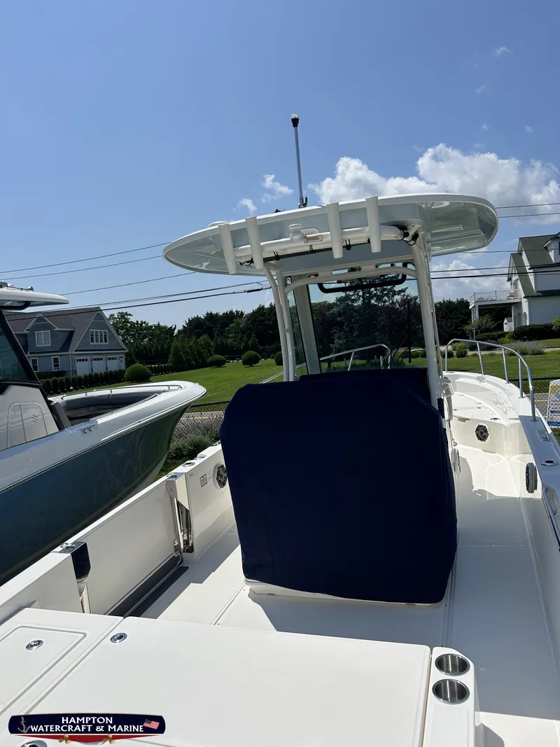 Slide: The Image of 2023 Boston Whaler 280 Dauntless boat docked under clear blue sky. - 6