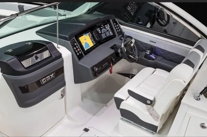 Slide: The Image of 2026 Chaparral 310 OSX boat cockpit with modern dashboard and seating. - 5