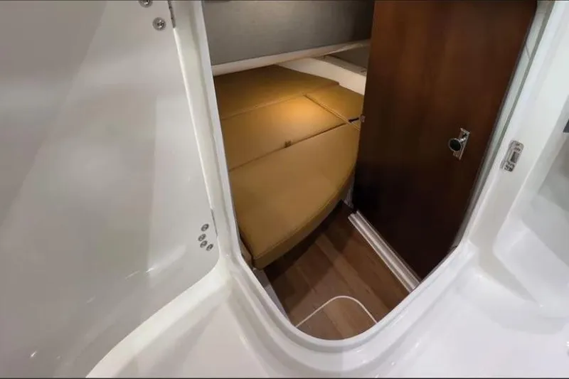Slide: The Image of 2026 Chaparral 310 OSX cabin interior with cozy seating and wooden accents. - 6