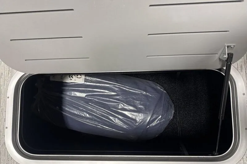 Slide: The Image of Storage compartment of 2026 Bennington 22 SSRSE boat, containing a wrapped item. - 17