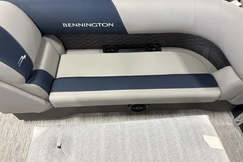 Slide: The Image of Bennington 22 SSRSE 2026 boat seating, featuring blue and gray upholstery with quilted accents. - 18