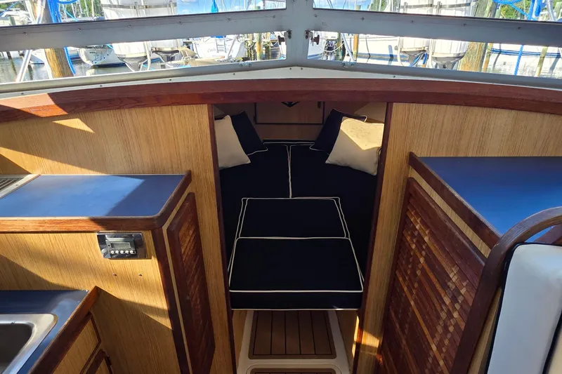 Slide: The Image of Interior of 1983 Bertram 28 Flybridge Cruiser with cozy cabin and wooden finishes. - 25