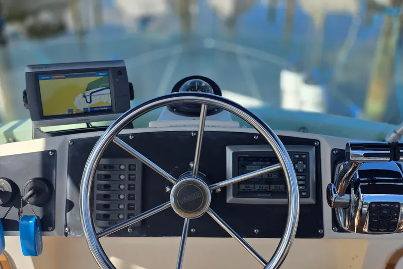 Slide: The Image of Helm of 1983 Bertram 28 Flybridge Cruiser with navigation equipment and steering wheel. - 7
