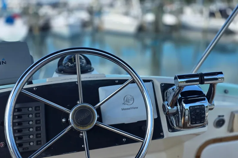 Slide: The Image of Helm of 1983 Bertram 28 Flybridge Cruiser with steering wheel and controls. - 8