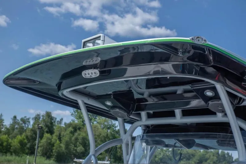 Slide: The Image of 2014 Nor-Tech 390 Sport Cuddy Center Console boat top view under blue sky. - 13