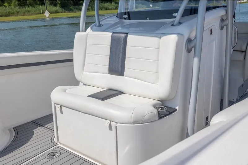 Slide: The Image of 2014 Nor-Tech 390 Sport Cuddy Center Console with white seating, on a calm waterway. - 2