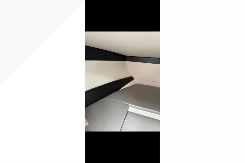 Slide: The Image of Interior of 2014 Nor-Tech 390 Sport Cuddy Center Console, featuring cushioned seating. - 4