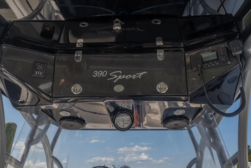 Slide: The Image of 2014 Nor-Tech 390 Sport Cuddy Center Console dashboard with navigation equipment and controls. - 6