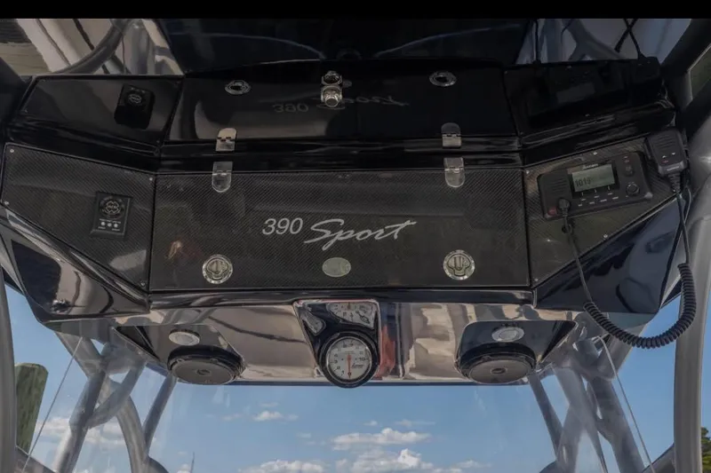 Slide: The Image of 2014 Nor-Tech 390 Sport Cuddy Center Console dashboard with controls and gauges. - 9