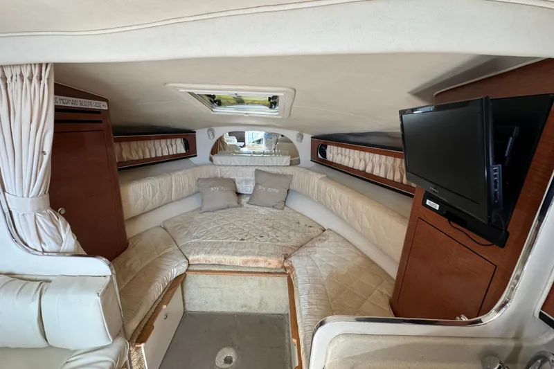 Slide: The Image of Interior of 2003 Sea Ray 280 Sundancer with cozy seating and mounted TV. - 12